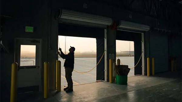 Worker Opening Warehouse Loading Dock Doors